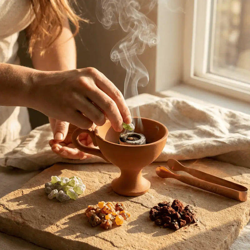 Hands preparing sacred resin ritual