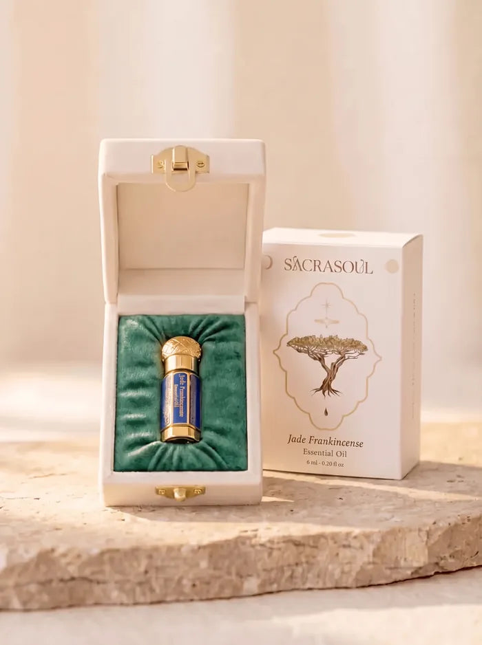 Jade Frankincense Oil — the gold-and-blue flacon in its velvet box, beside the engraved packaging